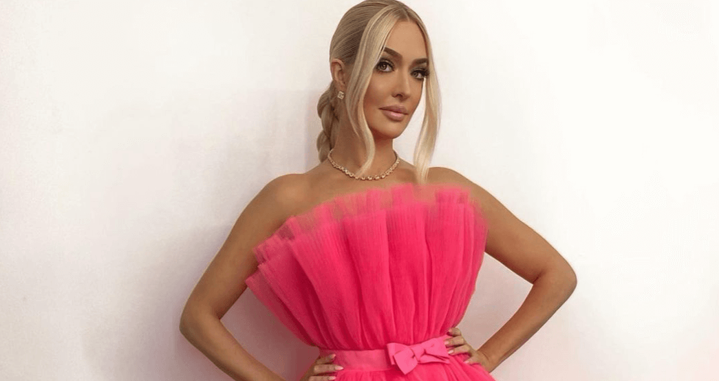 Erika Jayne looks chipper as she smiles in pink Fiorucci midi